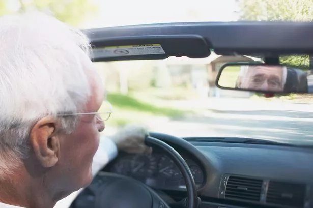 Man driving convertible
