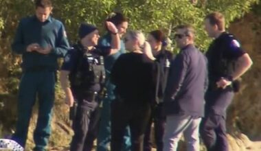 An investigation is underway after a woman's body was found floating in Currumbin Creek (pictured, emergency crews at the scene)