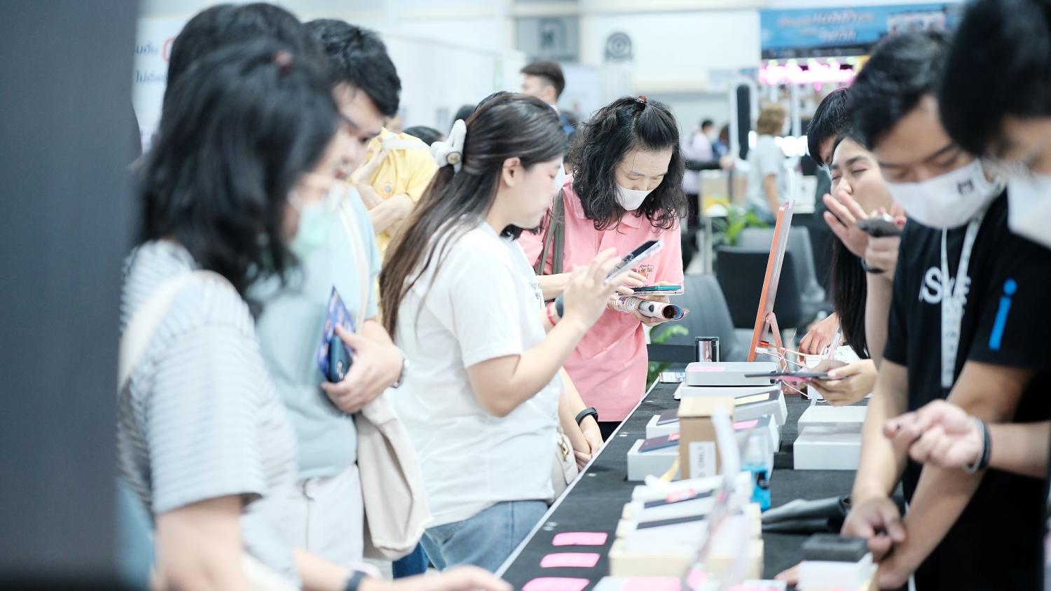 People examine devices on display at Thailand Mobile Expo 2025, held early this year. While foldable smartphones account for just 1.5% of total smartphone sales, they remain strategically important as vendors use them to target the premium segment.