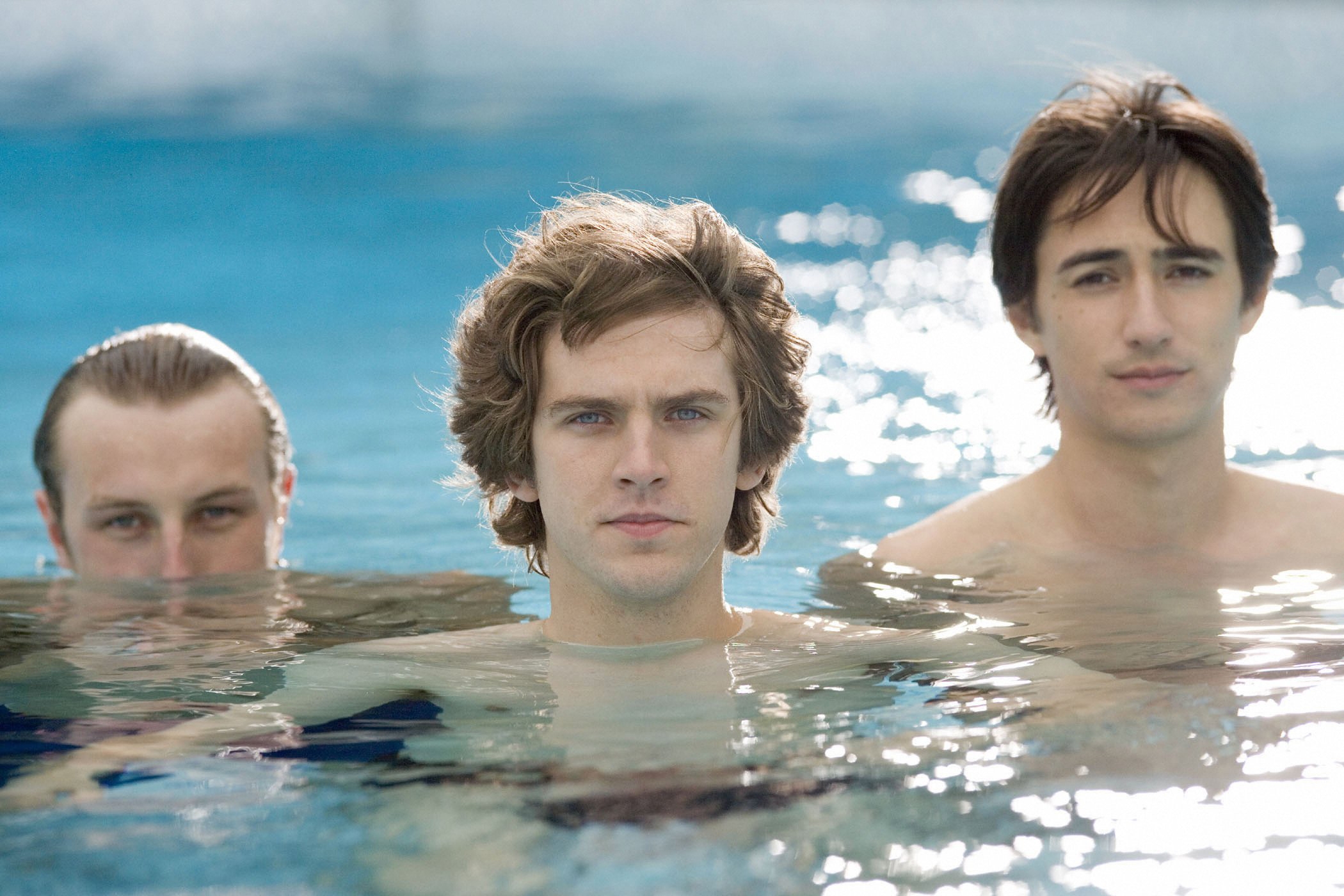 Three men in a pool: Toby Fedden, Nick Guest, and Wani Ouradi.