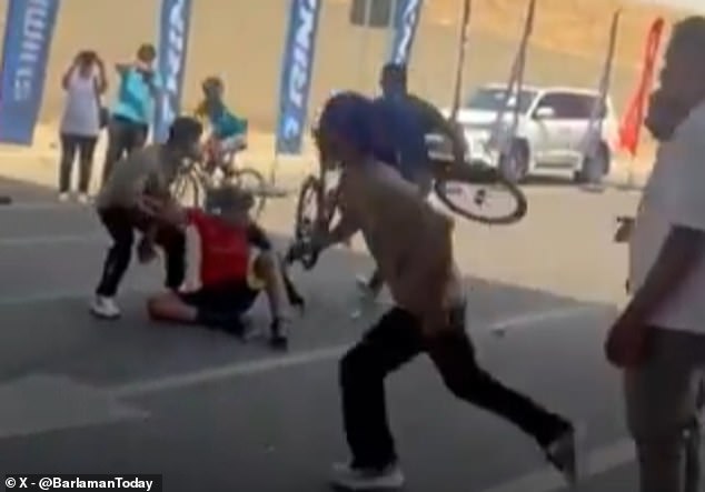 Competitors raced onto the road to try and help the fallen riders when the traffic had cleared