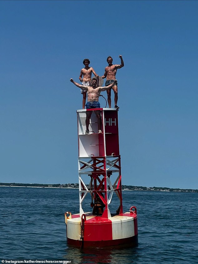 He also showed off his competitive side as he joined some of his in-laws to climb a tall red-and-white buoy, which Katherine shared a video of to her Instagram Stories
