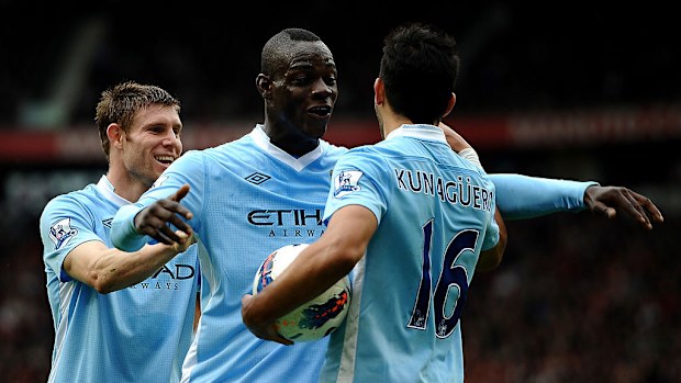 Sergio Aguero of Manchester City celebrates scoring a goal with teammates James Milner (L) and Mario Balotelli against Manchester United in 2011.