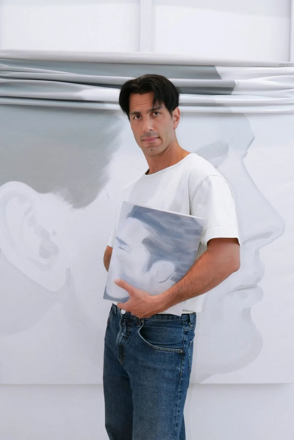 \u200bJwan Yosef poses for a photograph holding his book Intimacies