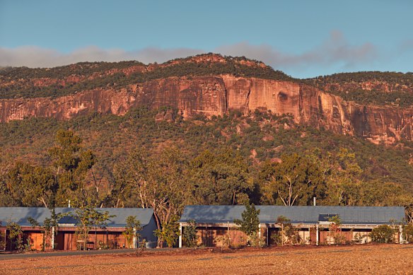 Mount Mulligan’s red standstone cliffs  tower above the lodge.