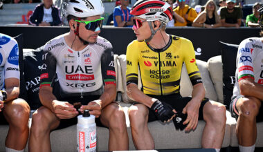João Almeida and Jonas Vingegaard sit on a bench next to each other talking before stage 7 of the Vuelta a Espana