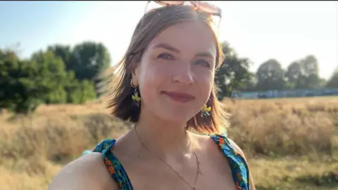 BBC BBC journalist Erin Lister smiles at the camera 