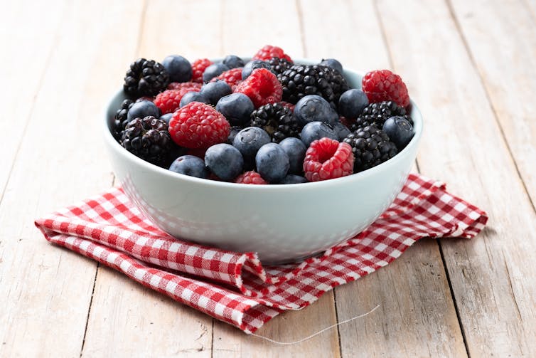 A bowl full of berries, including blackberries, raspberries and blueberries.