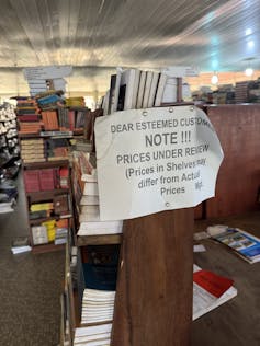 A bookshop with rows of books haphazardly displayed.