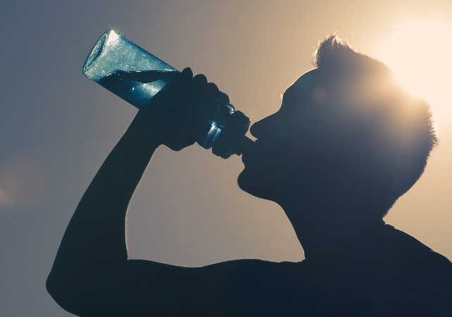 man drinking water from a bottle