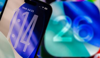 An iPhone lock screen with a clear clock next to the number 26.