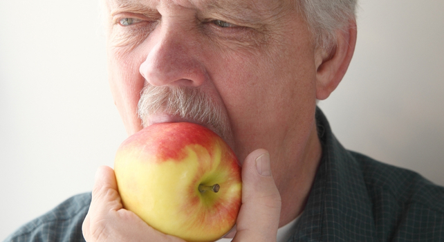 man eating apple