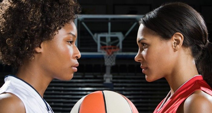 two women basketball players face off