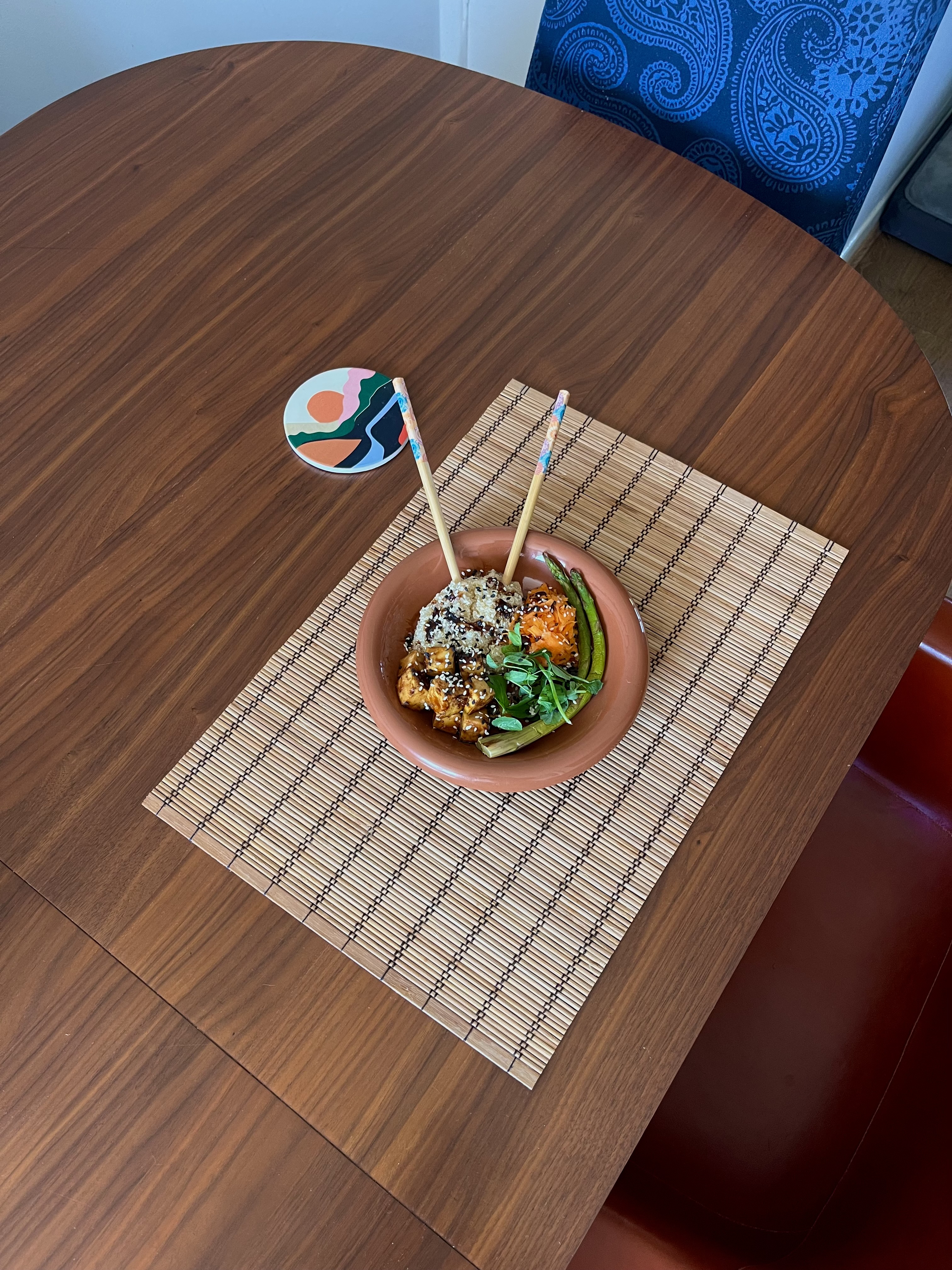 A bowl of teriyaki tofu, with quinoa, asparagus and shredded pickled carrot