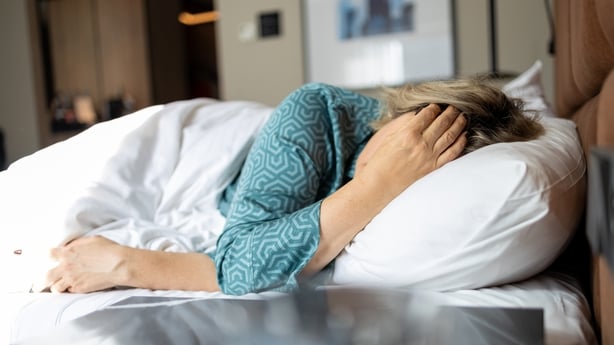 Mature woman in depression lying in bed covered with blanket. Melancholy mood, mental health, menopause Life problem. Insomnia and psychological issues.