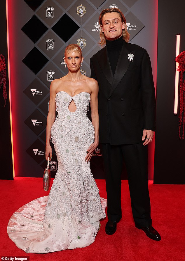 While the comment section was filled with people praising Dee's eye-catching red carpet look, it was a post from Darcy that took the cake. 'I am so in love with you,' the AFL star wrote
