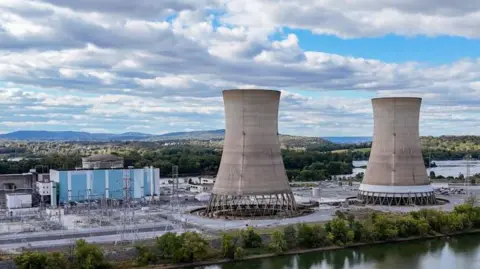 Bloomberg via Getty Images Two huge cooling towers stand Three Mile Island, to the left is blue and white power station.