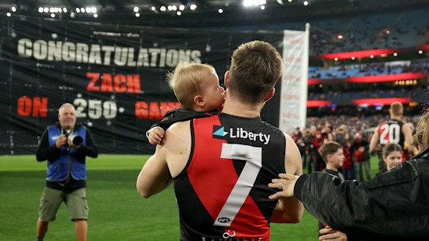 Zach Merrett of the Bombers is congratulated on his 250th game.
