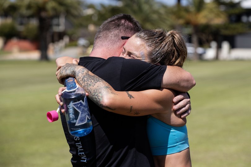 Brooke McIntosh completes her record-breaking 14,000km run around Australia in City Beach today after more than 180 days on the road. Her journey was aimed at raising awareness and funds for mental health through the Blue Tree Project. Also pictured is Brooke's partner Matthew Guscott.