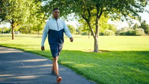 Getty Images Mature Man Exercising in a Park in the Morning 