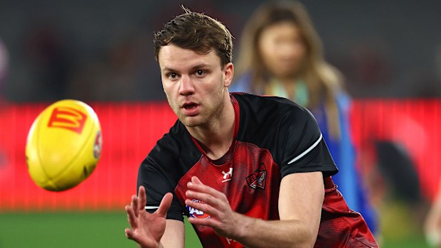 Jordan Ridley of the Bombers warms up.