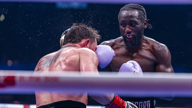 Canelo Alvarez takes a punch to the face from Terence Crawford during their undisputed super middleweight championship fight 