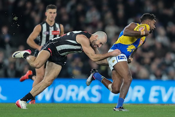 Collingwood midfielder Steele Sidebottom tackles Liam Ryan of the Eagles.