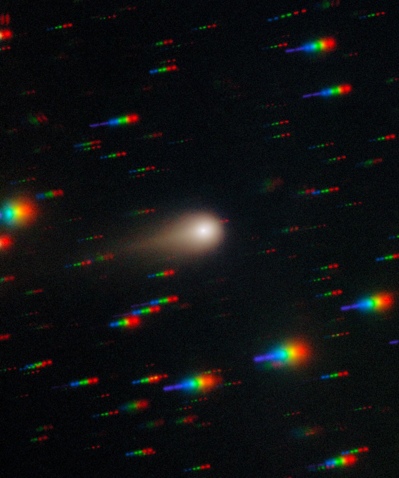 A white blur against a black background of multicolored streaks
