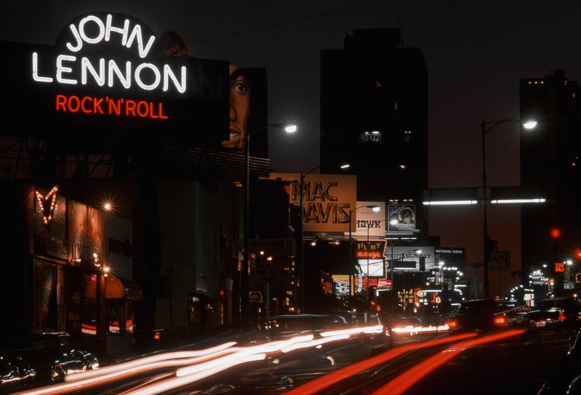 A view of the Sunset Strip looking west with billboards for John Lennon 'Rock 'N' Roll', Michael Jackson 'Forever, Michael', Mac Davis 'Burnin' Thing', David Bowie 'Young Americans' and the nightclub Filthy McNasty's in April 1975 in Los Angeles, California.