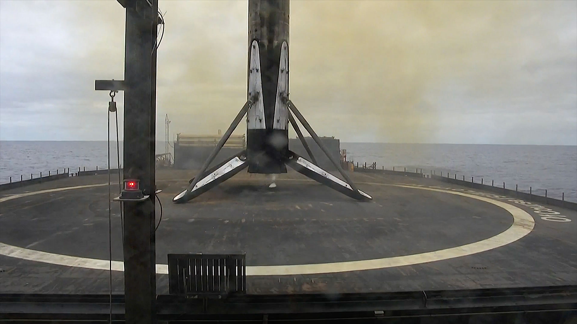 the first stage of an orbital class rocket stands on its landing legs after returning from a trip to space and back