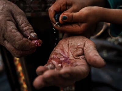 A palm is extended as seeds fall into it