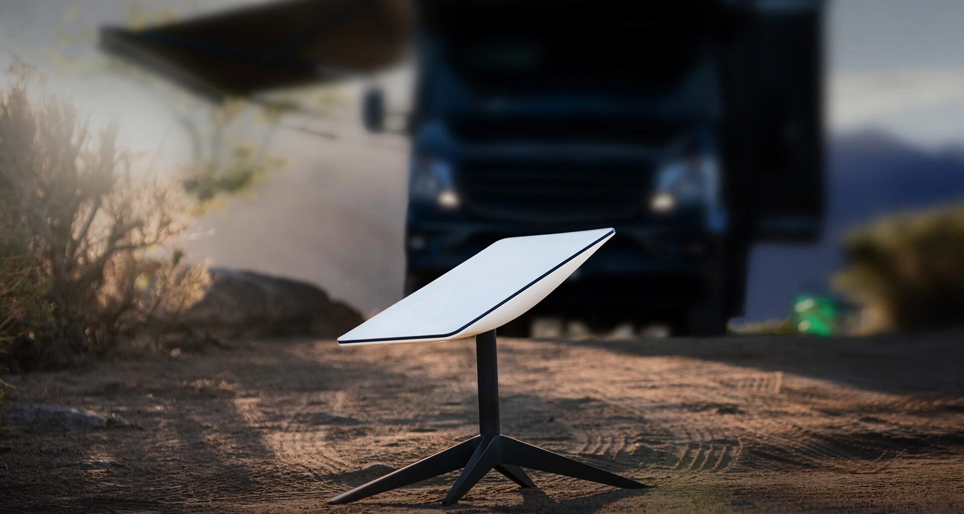 a small white rectangle on a black tripod rests on the ground