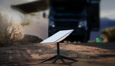 a small white rectangle on a black tripod rests on the ground