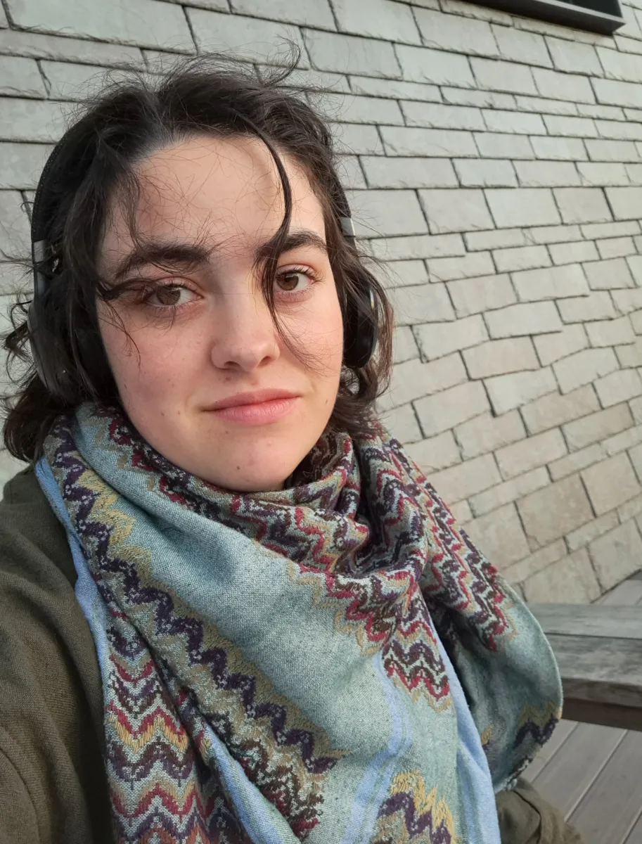 Sorrel Ricou sitting outdoors wearing a colorful scarf