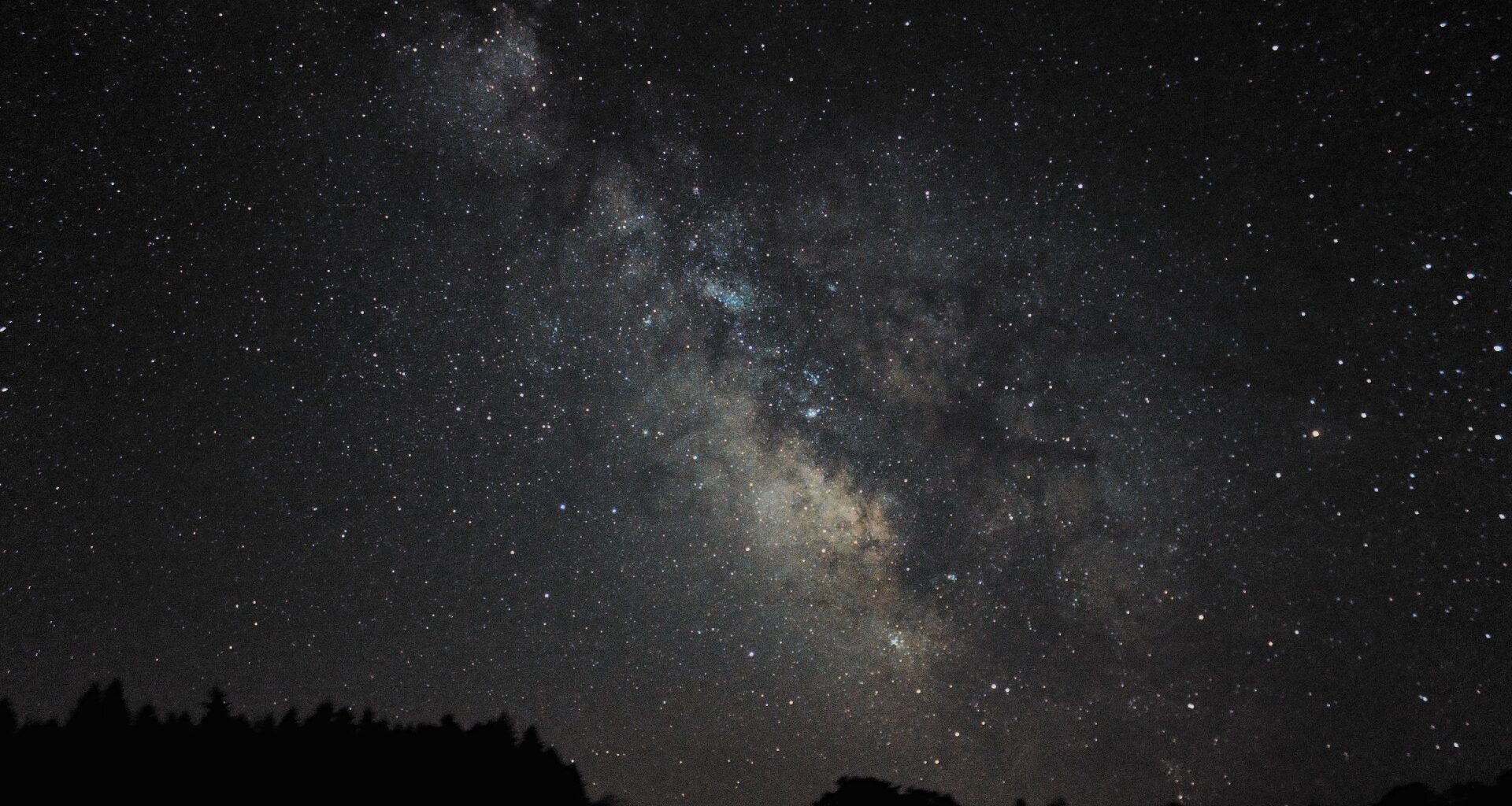a wisp of white light crosses the night sky
