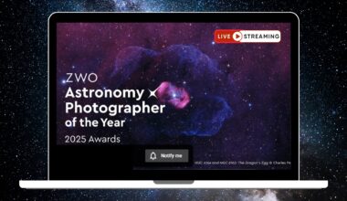 An image of a blue and red bubble-like nebula is pictured against a starry background within the screen of a laptop. The words 'ZWO Astronomy Photographer of the Year 2025 Awards' are visible to the lower left of the screen and the words 'Live Streaming' are written to the upper right.