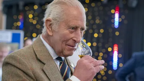 Getty Images King Charles with a whisky glass