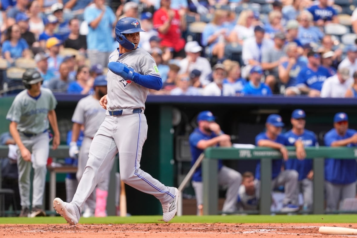 Baseball player runs with a glove and helmet on