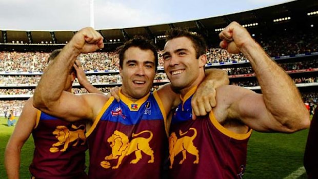 Chris (left) and Brad Scott celebrate their 2002 Brisbane Lions premiership win.