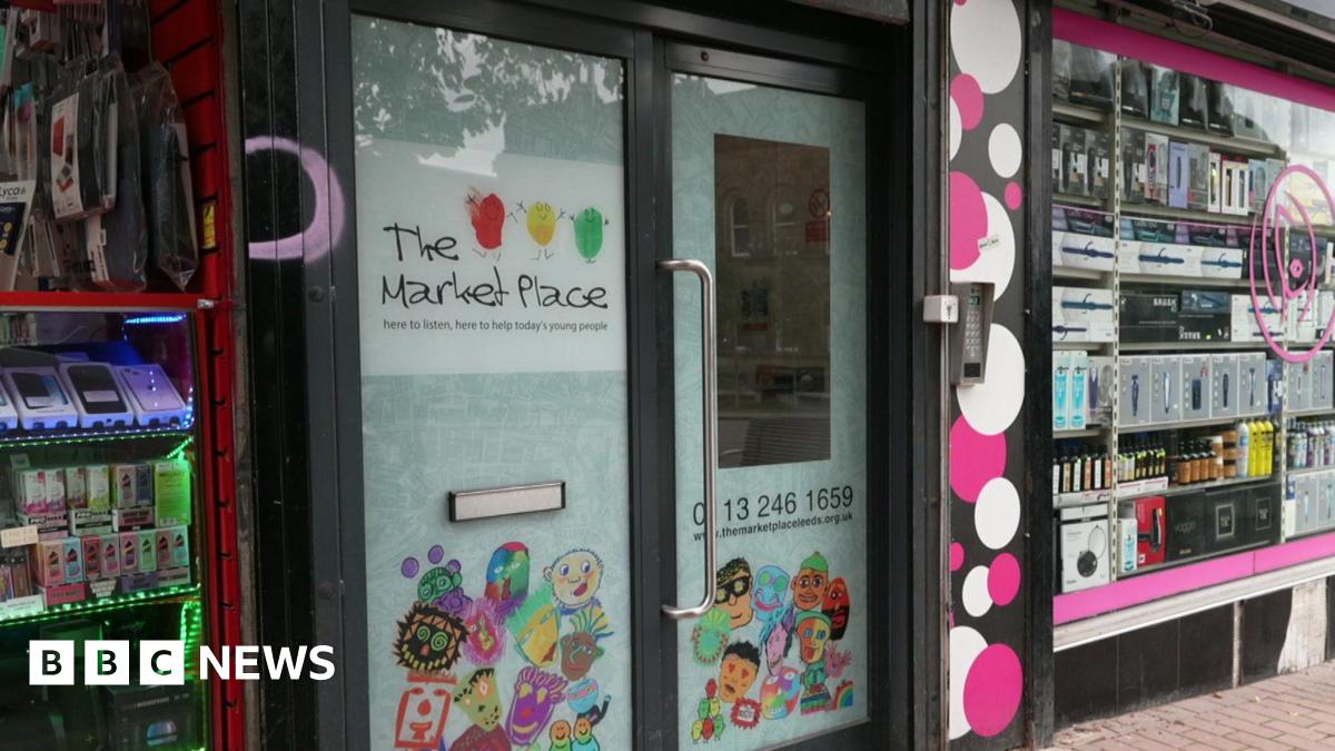 A set of double doors with the name 'The Market Place' emblazoned across them. Some cartoon figures are on the bottom of the door.