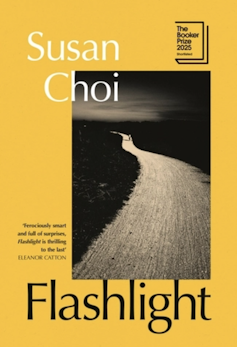 A yellow book cover of a novel showing a wet road in the moonlight called Flashlight.