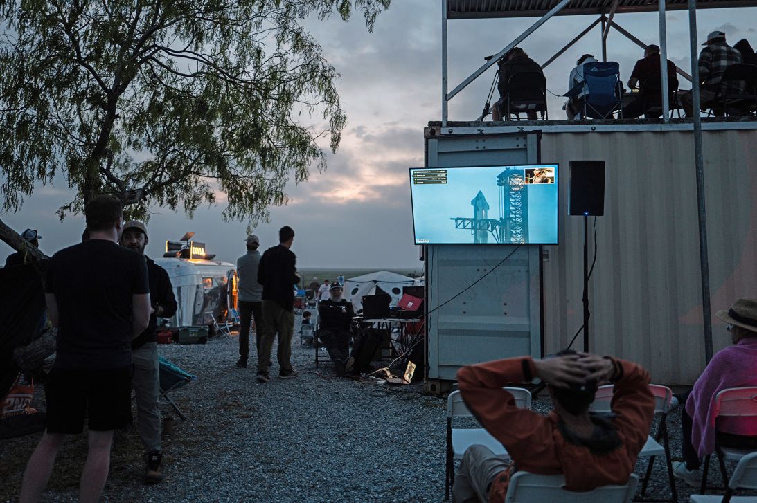 People wait together at Rocket Ranch's lookout post ahead of the third fully integrated flight test of SpaceX's Starship rocket in March 2024 near Brownsville, Texas.