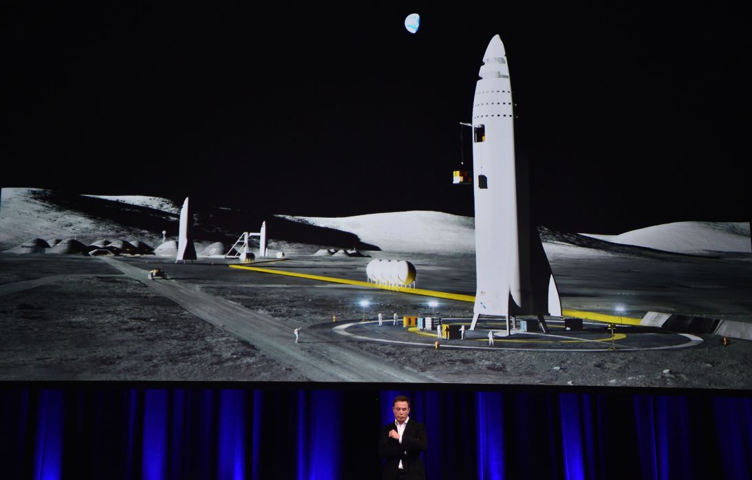 SpaceX CEO Elon Musk speaks below an illustration of his envisioned Mars rocket during the 68th International Astronautical Congress 2017 in Adelaide, Australia, in September 2017.