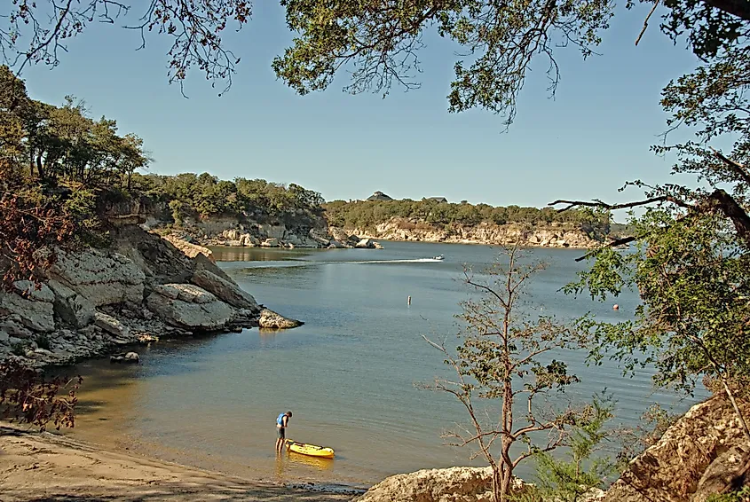 View of Lake Texoma at Eisenhower State Park in Denison, Texas, and a man putting on his life vest to go kayaking.