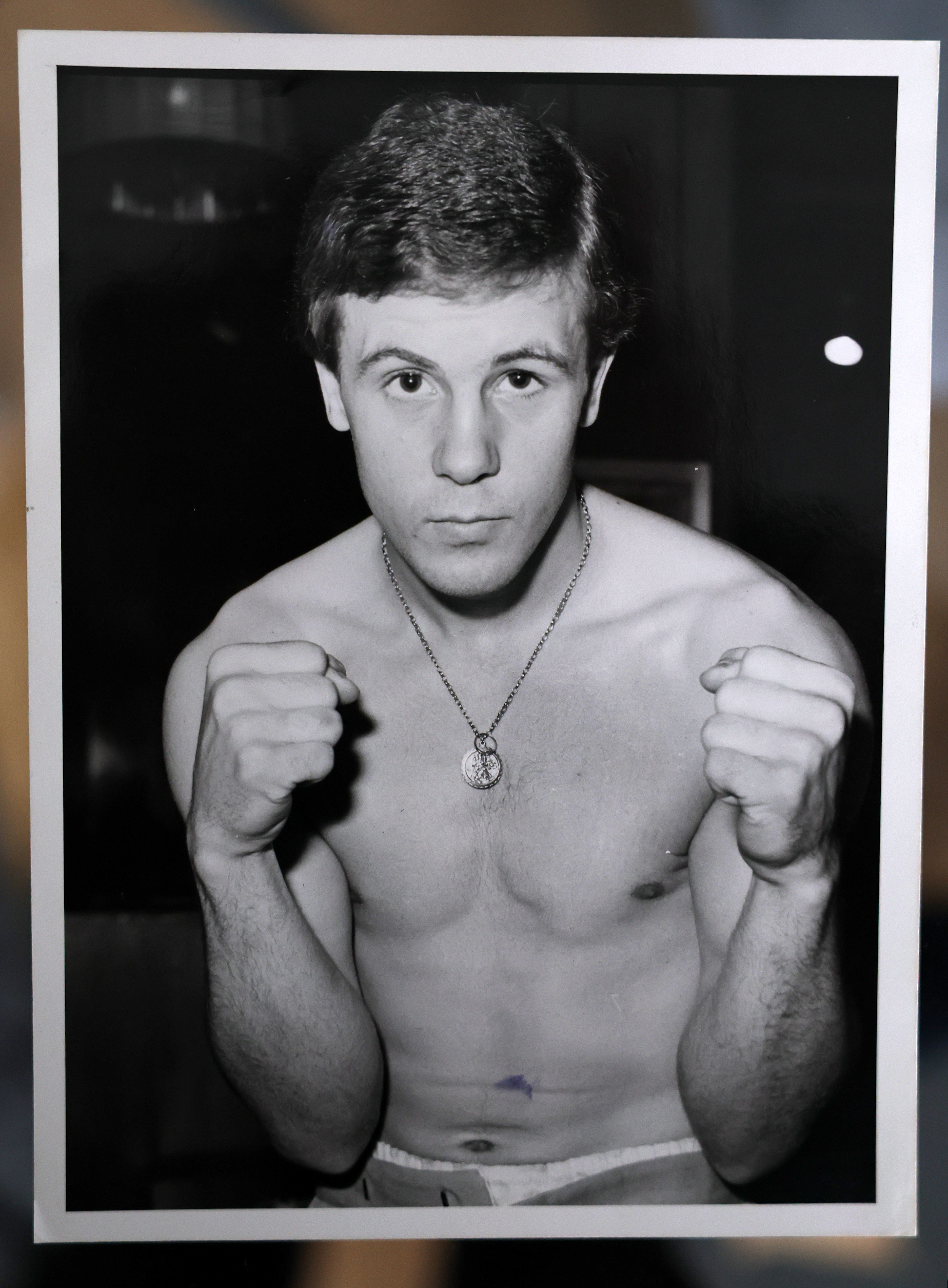 Jimmy Batten, boxer, in a black and white portrait photo with fists raised.