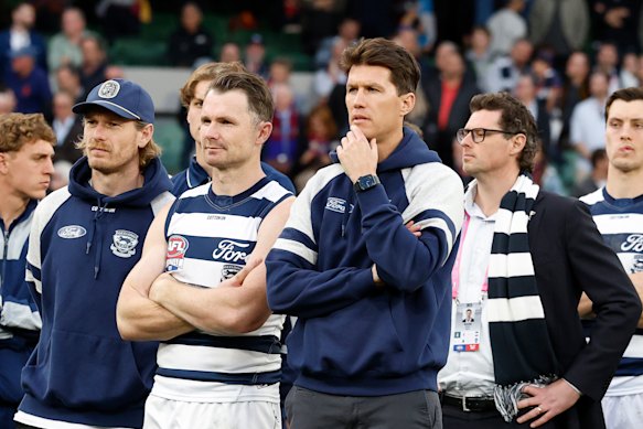 The disappointed Cats watch on at the medal presentation after losing the grand final to Brisbane.