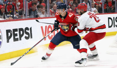 Ottawa Senators defenseman Jake Sanderson (85) and New Jersey Devils center Nico Hischier (13)