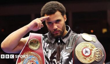 Moses Itauma salutes the cameras holding his belts