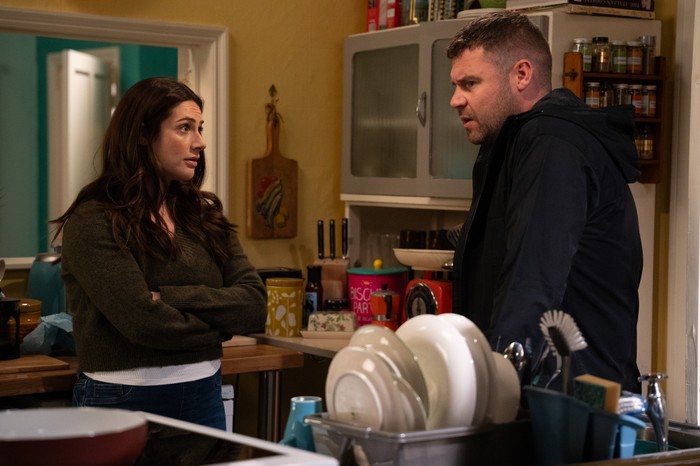 05_11_emm_victoria_aaron_02 Vic stands with her arms folded staring at Aaron in Emmerdale