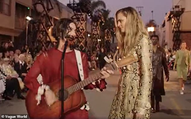 As she made her way down the runway, Abrams crossed paths with other models donning eye-catching looks, such as Cara Delevingne